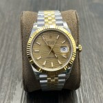 Datejust series men's and women's watches with wave pattern gold dial, gold bezel, 36mm and 41mm sizes, and two-tone five-link bracelet.